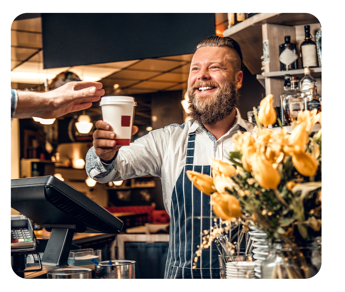 Cashier handing coffee order.