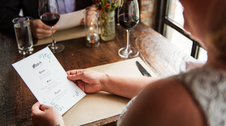 Restaurant operator reviewing menu with focus on menu innovation and dining experience