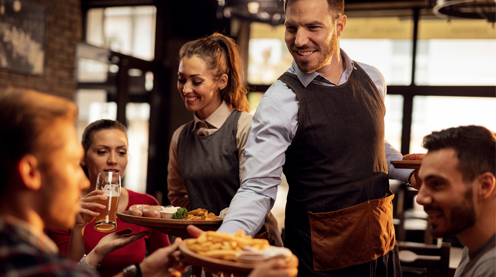 Restaurant staff serving guests, representing how restaurant supply chain risks impact operations
