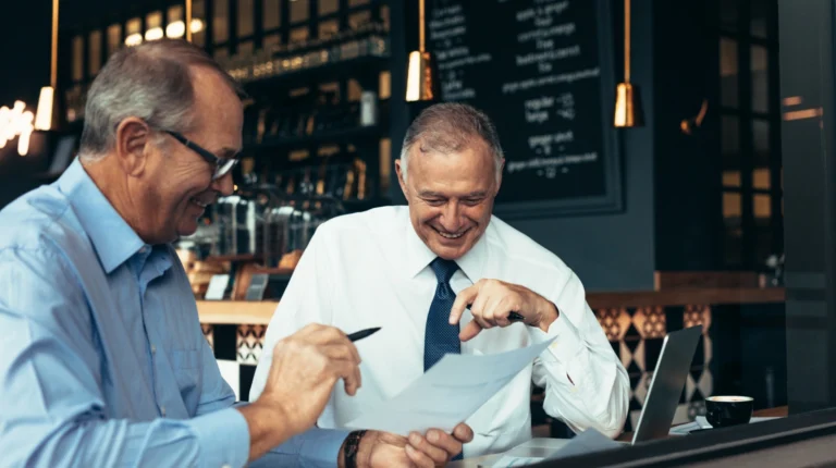 Restaurant operators reviewing financial reports and restaurant profitability data together