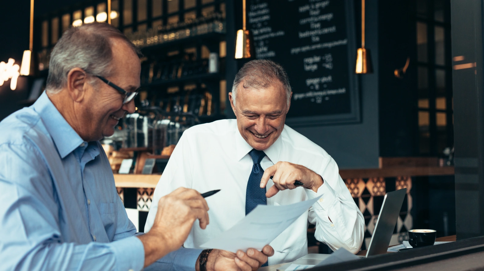 Restaurant operators reviewing financial reports and restaurant profitability data together